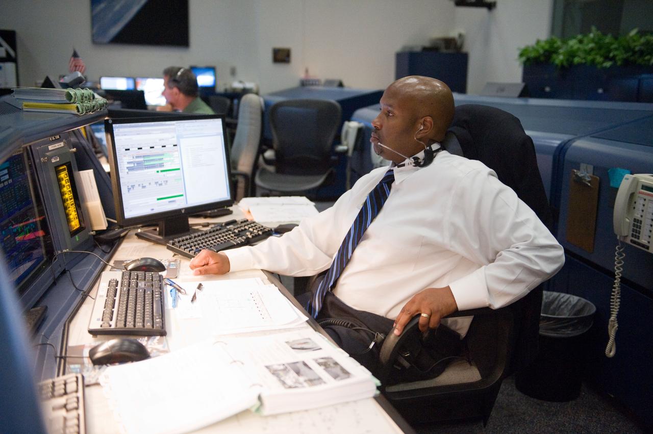 PHOTO DATE: 12 July 2011 LOCATION: Bldg. 30 FCR-1, EVA, WFCR & Bldg. 7 EVA Center. SUBJECT: STS-135 flight controllers on console for EVA. PHOTOGRAPHER: Mark Sowa