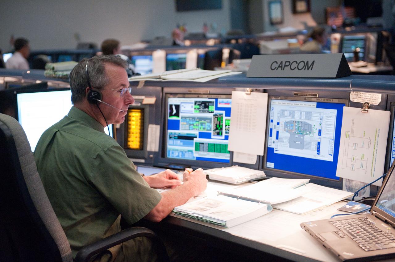 PHOTO DATE: 12 July 2011 LOCATION: Bldg. 30 FCR-1, EVA, WFCR & Bldg. 7 EVA Center. SUBJECT: STS-135 flight controllers on console for EVA. PHOTOGRAPHER: Mark Sowa