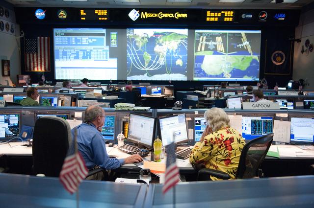NASA image: STS-135 Flight Controllers on Console. Orbit 3