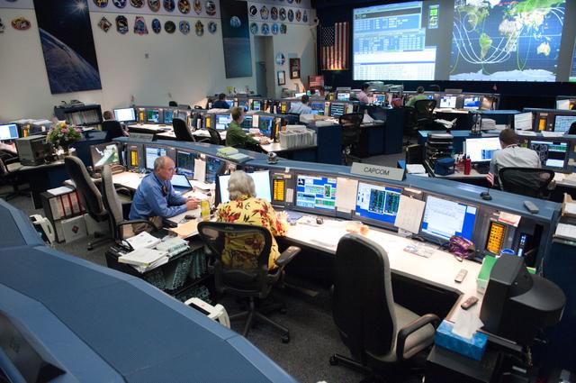 NASA image: STS-135 Flight Controllers on Console. Orbit 3