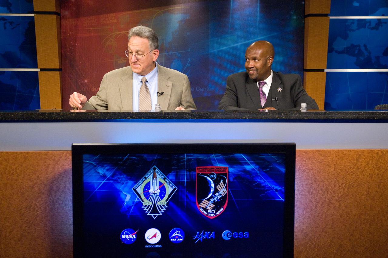 JSC2011-E-065977 (10 July 2011) --- STS-135 lead flight director Kwatsi Alibaruho (right) and Public Affairs Office moderator Rob Navias are pictured during a flight day three mission status briefing at NASA's Johnson Space Center. Photo credit: NASA