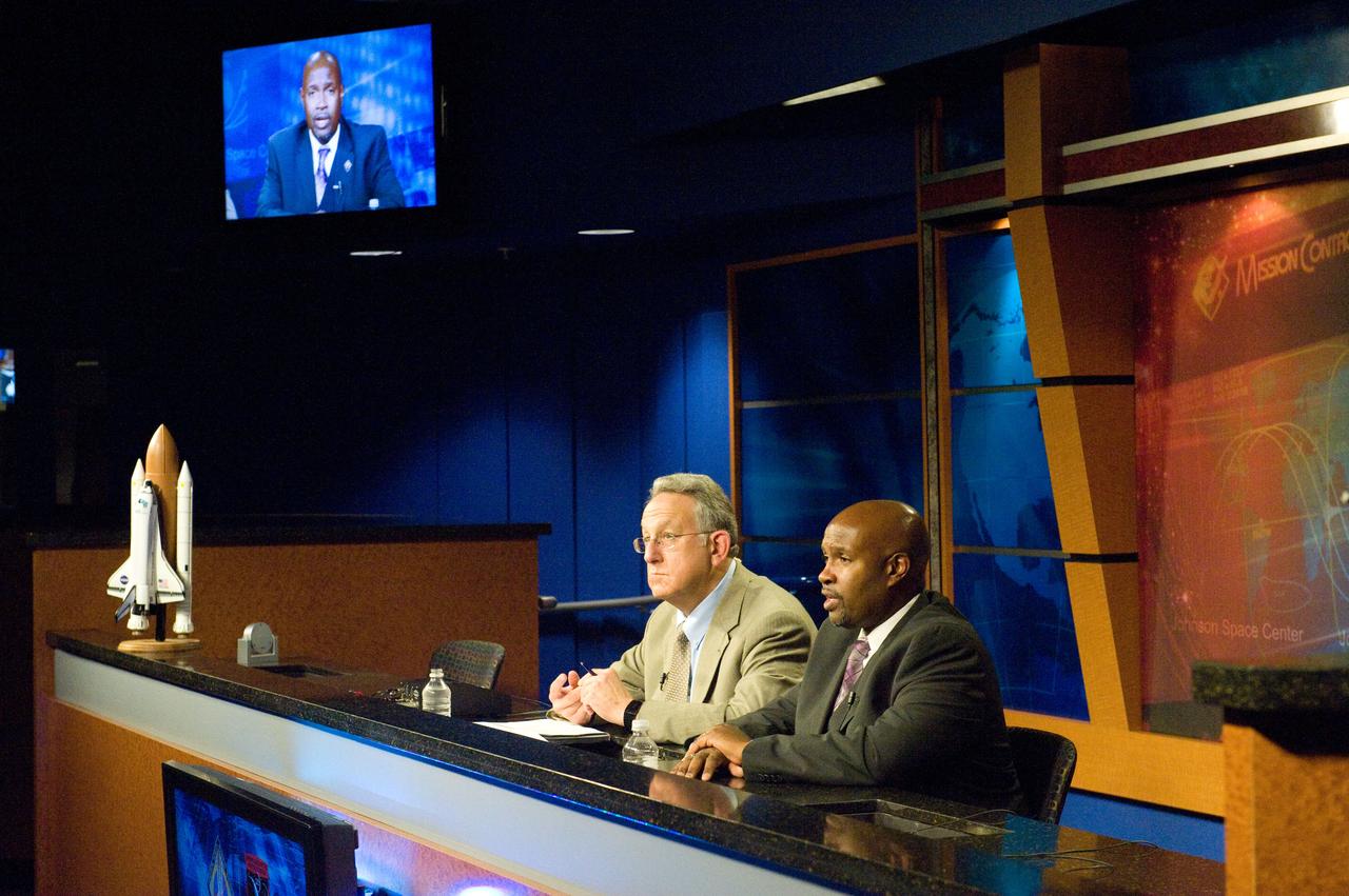 JSC2011-E-065983 (10 July 2011) --- STS-135 lead flight director Kwatsi Alibaruho (right) and Public Affairs Office moderator Rob Navias are pictured during a flight day three mission status briefing at NASA's Johnson Space Center. Photo credit: NASA