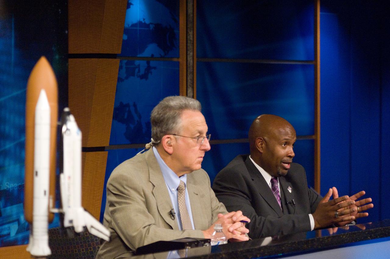 JSC2011-E-065999 (10 July 2011) --- STS-135 lead flight director Kwatsi Alibaruho (right) and Public Affairs Office moderator Rob Navias are pictured during a flight day three mission status briefing at NASA's Johnson Space Center. Photo credit: NASA