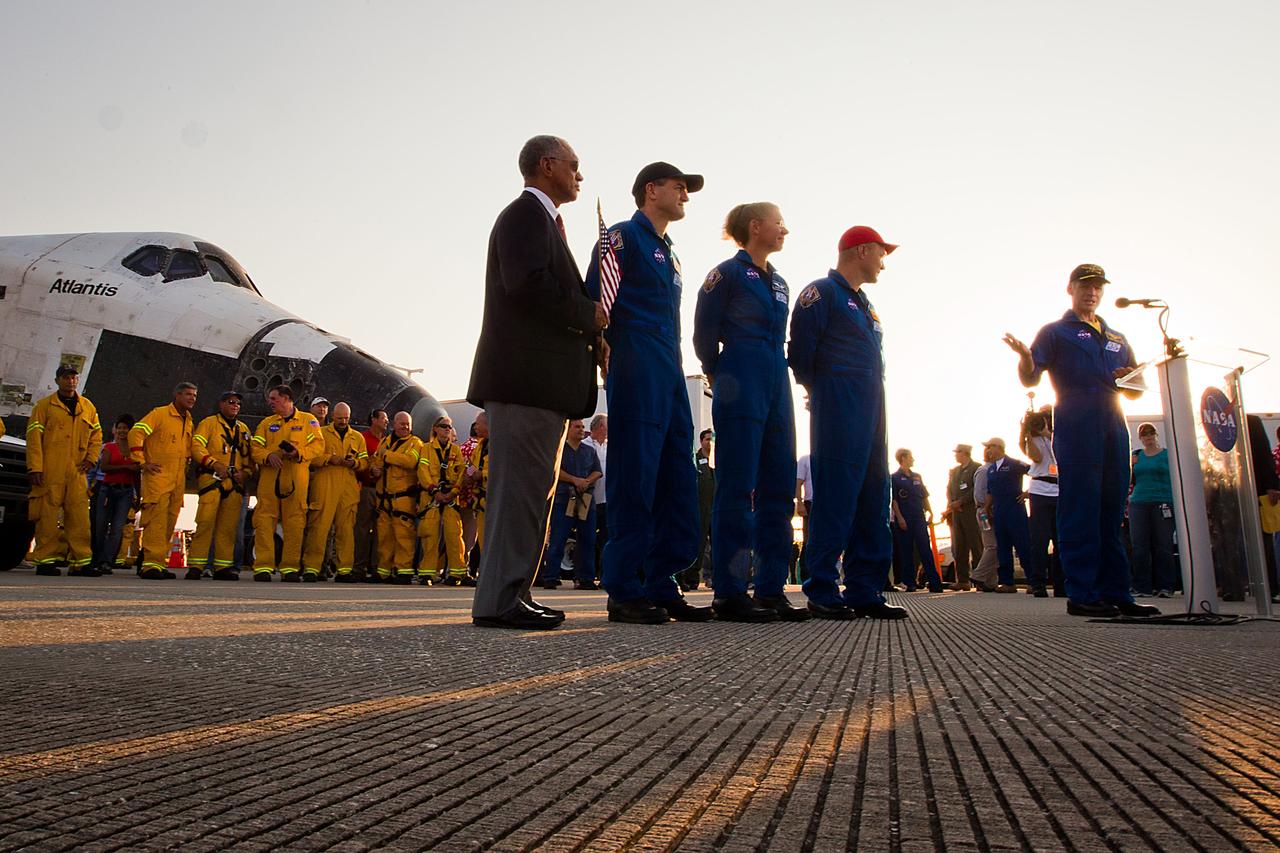 JSC2011-E-067995 (21 July 2011) --- NASA astronaut Chris Ferguson, STS-135 commander, makes a public statement as, from left, NASA Administrator Charles Bolden, along with NASA astronauts Rex Walheim, Sandy Magnus and Doug Hurley look on after the space shuttle Atlantis landed on July 21 at the Kennedy Space Center in Florida. The landing completed STS-135, the final mission of the NASA Space Shuttle Program. Photo credit: NASA Photo/Houston Chronicle, Smiley N. Pool