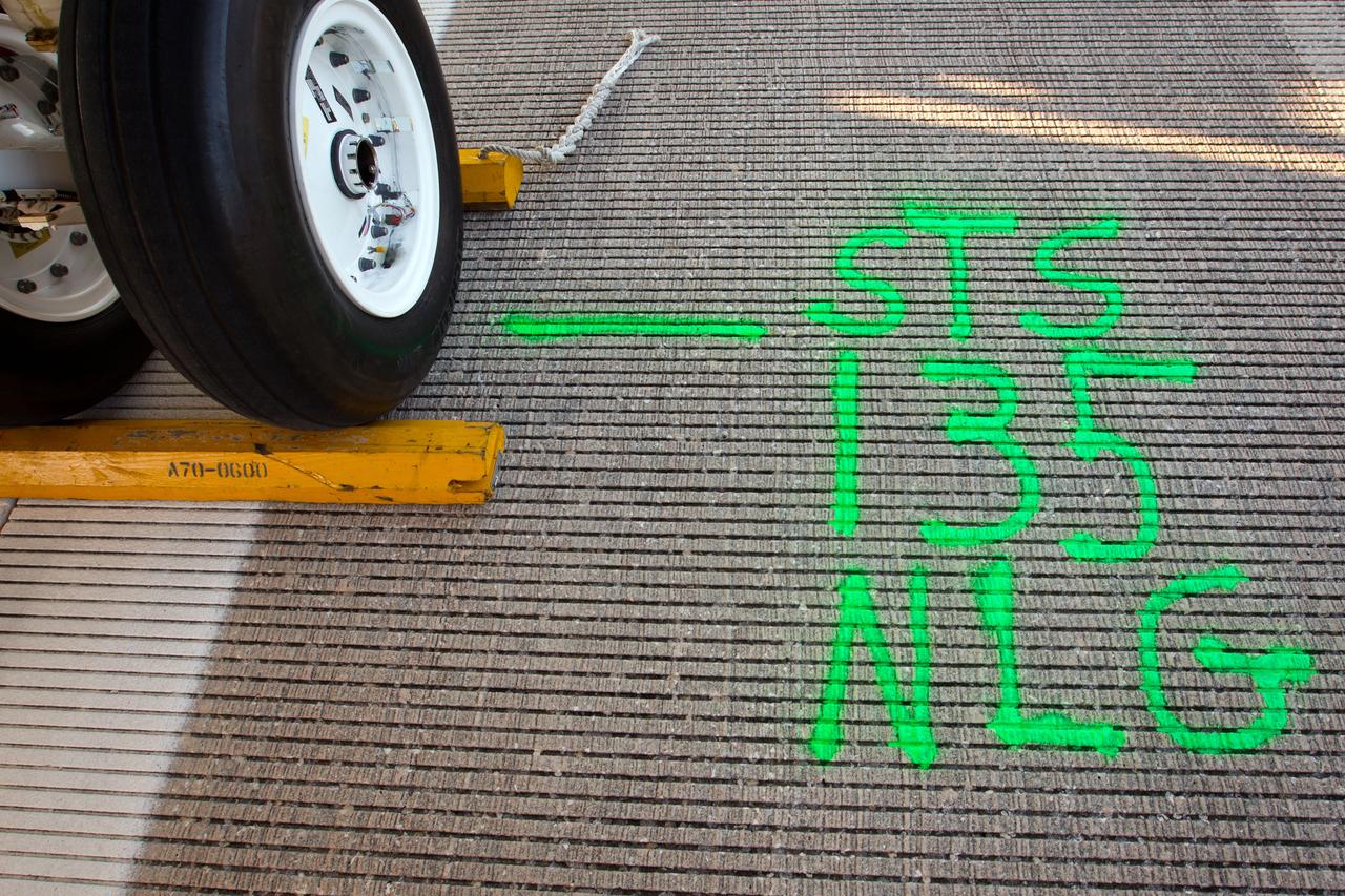 JSC2011-E-068007 (21 July 2011) --- Green paint marks the location where Atlantis' nose landing gear came to a stop on the runway after the space shuttle landed at the Kennedy Space Center in Florida on July 21, 2011.  The landing completed STS-135, the final mission of the NASA Space Shuttle Program. Photo credit: NASA Photo/Houston Chronicle, Smiley N. Pool