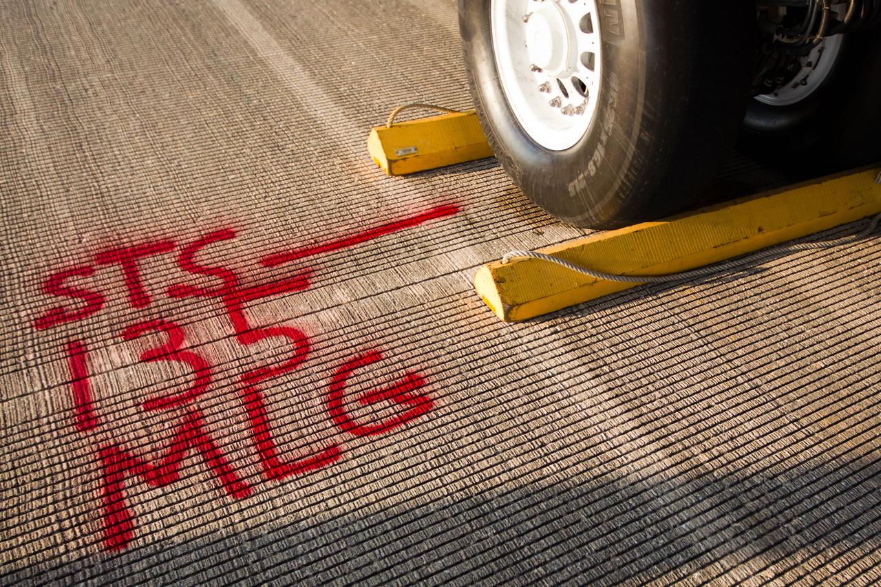JSC2011-E-068008 (21 July 2011) --- Red paint marks the location where Atlantis' main landing gear came to a stop on the runway after the space shuttle landed at the Kennedy Space Center in Florida on July 21, 2011.  The landing completed STS-135, the final mission of the NASA Space Shuttle Program. Photo credit: NASA Photo/Houston Chronicle, Smiley N. Pool