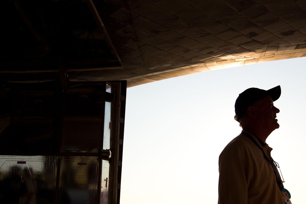 JSC2011-E-068012 (21 July 2011) --- Milt Heflin, associate director (technical) of the Johnson Space Center, stands under the wing of the space shuttle Atlantis after it landed on July 21, 2011 at the Kennedy Space Center in Florida. The landing completed STS-135, the final mission of the NASA Space Shuttle Program. Photo credit: NASA Photo/Houston Chronicle, Smiley N. Pool
