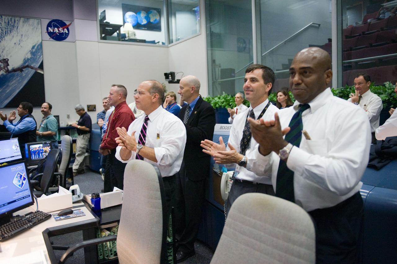 Photograph STS-135 entry flight controllers on console during the landing of Space Shuttle Atlantis with Flight Director Tony Ceccacci.  Photo Date: July 21, 2011.  Location: Building 30 south - WFCR.  Photographer: Robert Markowitz