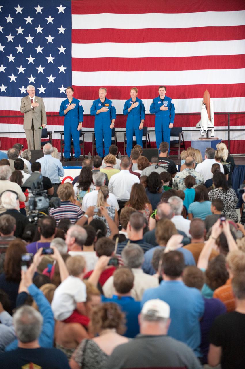 JSC2011-E-070230 (22 July 2011) --- NASA's Johnson Space Center (JSC) director Michael L. Coats (left) and STS-135 crew members are pictured during the STS-135 crew return ceremony on July 22, 2011 at Ellington Field near JSC. Pictured from second left are NASA astronauts Chris Ferguson, commander; Doug Hurley, pilot; Sandy Magnus and Rex Walheim, both mission specialists. A large crowd of supporters is visible in the foreground. Photo credit: NASA