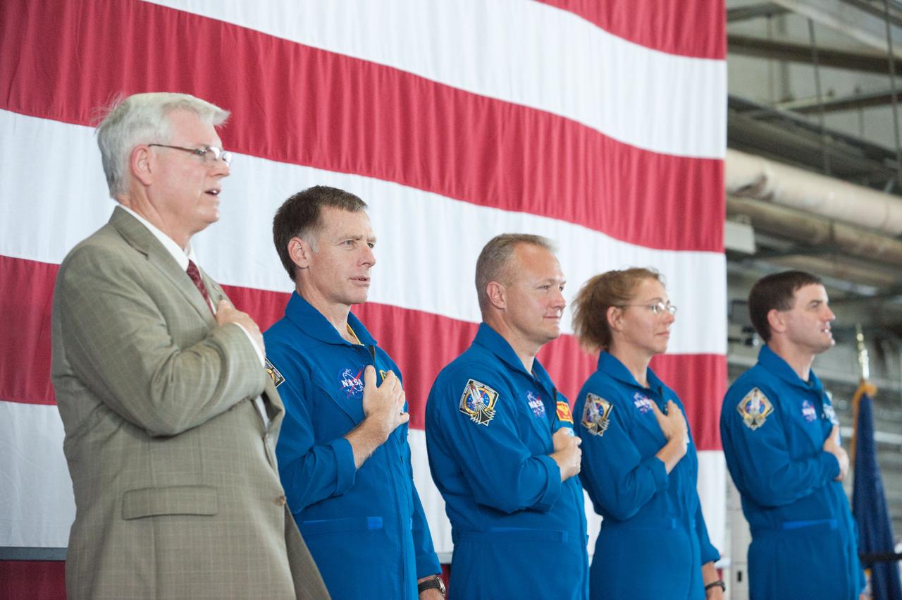JSC2011-E-070270 (22 July 2011) --- NASA's Johnson Space Center (JSC) director Michael L. Coats (left) and STS-135 crew members are pictured during the STS-135 crew return ceremony on July 22, 2011 at Ellington Field near JSC. Pictured from second left are NASA astronauts Chris Ferguson, commander; Doug Hurley, pilot; Sandy Magnus and Rex Walheim, both mission specialists. Photo credit: NASA