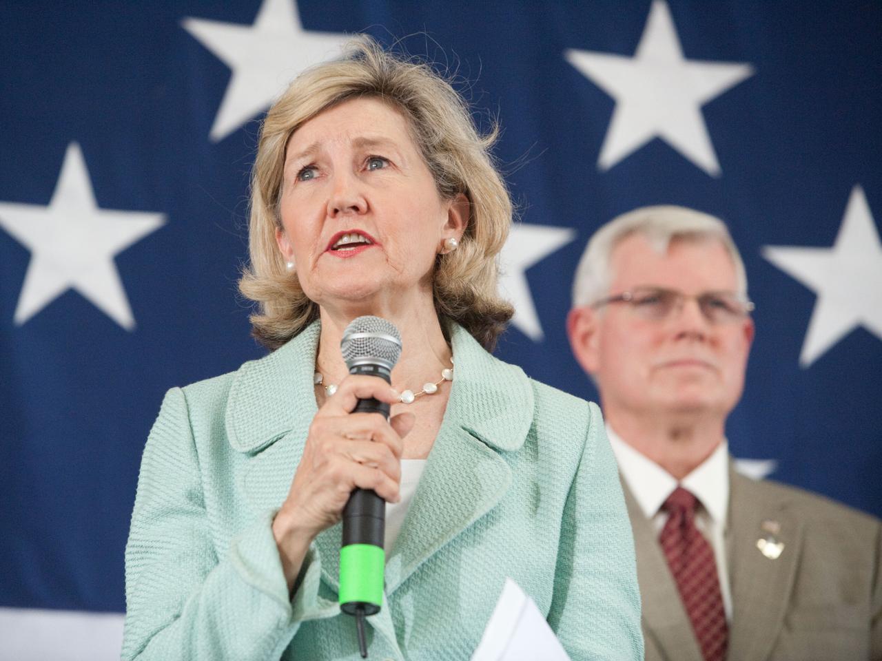 JSC2011-E-070272 (22 July 2011) --- U.S. Senator Kay Bailey Hutchison (R.-Texas) speaks to a crowd on hand at Ellington Field?s Hangar 990 near NASA?s Johnson Space Center (JSC) during the STS-135 crew return ceremonies. JSC director Michael L. Coats is visible in the background. Photo credit: NASA