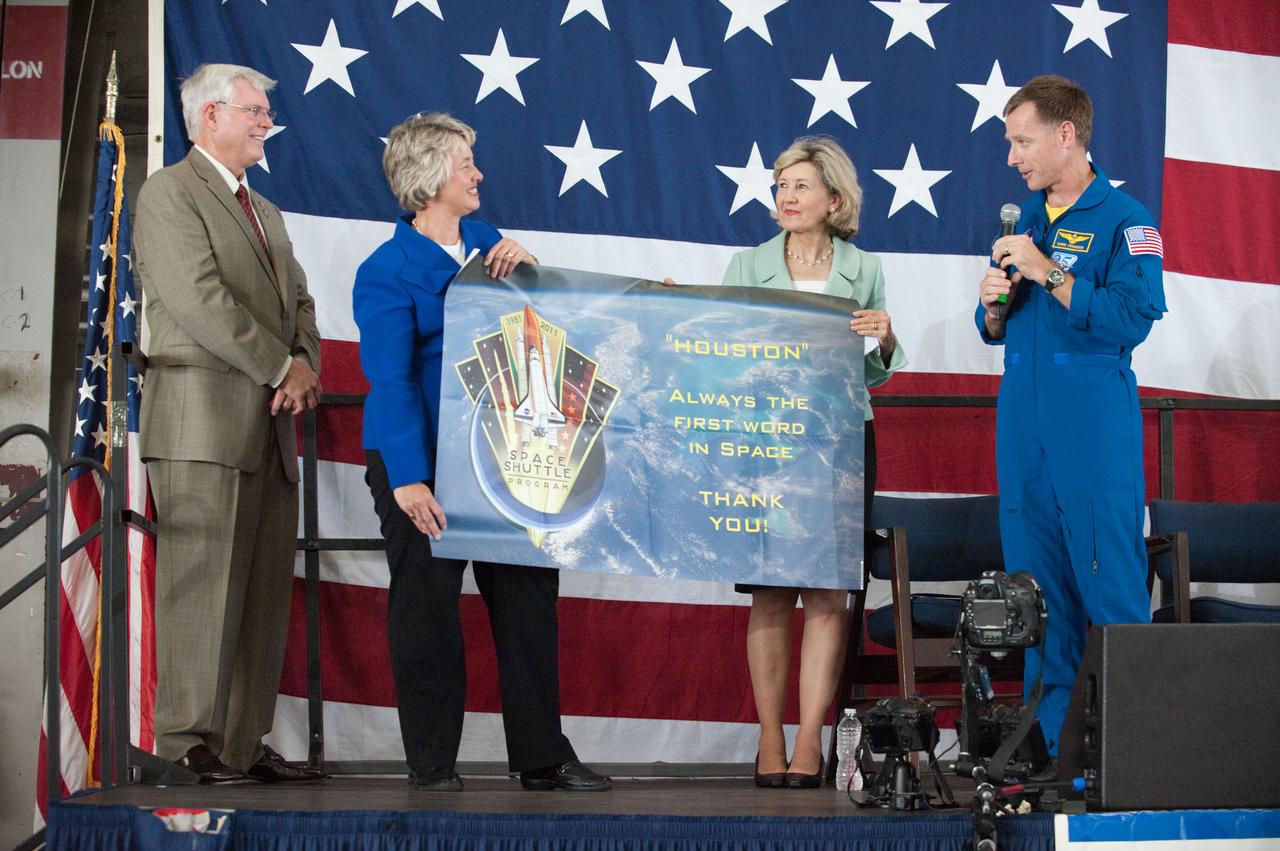 JSC2011-E-070276 (22 July 2011) --- NASA's Johnson Space Center (JSC) director Michael L. Coats (left), Houston Mayor Annise Parker, U.S. Senator Kay Bailey Hutchison (R.-Texas) and NASA astronaut Chris Ferguson, STS-135 commander, are pictured during the STS-135 crew return ceremony on July 22, 2011 at Ellington Field near JSC. Photo credit: NASA