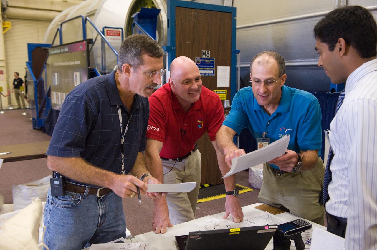 PHOTO DATE: 7-13-11  LOCATION: Bldg. 9NW - ISS Mockups    SUBJECT: Expedition 29/30 and Expedition 30/31 joint training sessions during Routine Ops training. Photograph crew working together and with instructors WORK ORDER: 02250-DCB-Exp 29-30 Training_07-13-11 PHOTOGRAPHER: Devin Boldt