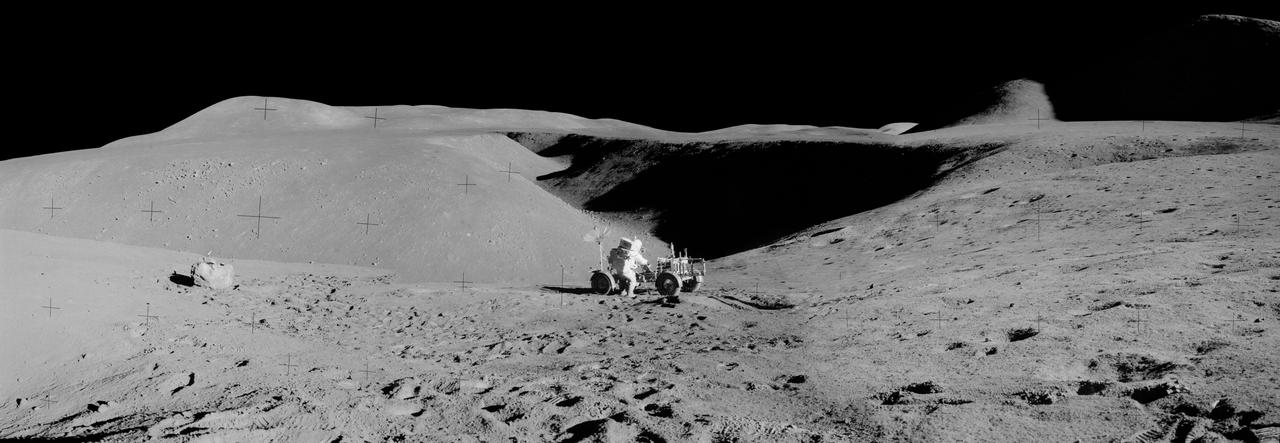 jsc2011e118359 - Panorama view of Apollo 15 lunar surface photos south of Station 2 taken by lunar module pilot James B. Irwin. Astronaut David R. Scott, mission commander, performs a task at the Lunar Roving Vehicle parked on the edge of Hadley Rille (Rima Hadley) during the first moonwalk of the mission. The panoramas were built by combining Apollo 15 images starting with frame AS15-85-11448 thru end frame AS15-85-11453. The panoramic images received minimal retouching by NASA imagery specialists, including the removal of lens flares that were problematic in stitching together the individual frames and blacking out the sky to the lunar horizon. These adjustments were made based on observations of the Moon walkers who reported that there are no stars visible in the sky due to the bright lunar surface reflection of the Sun.