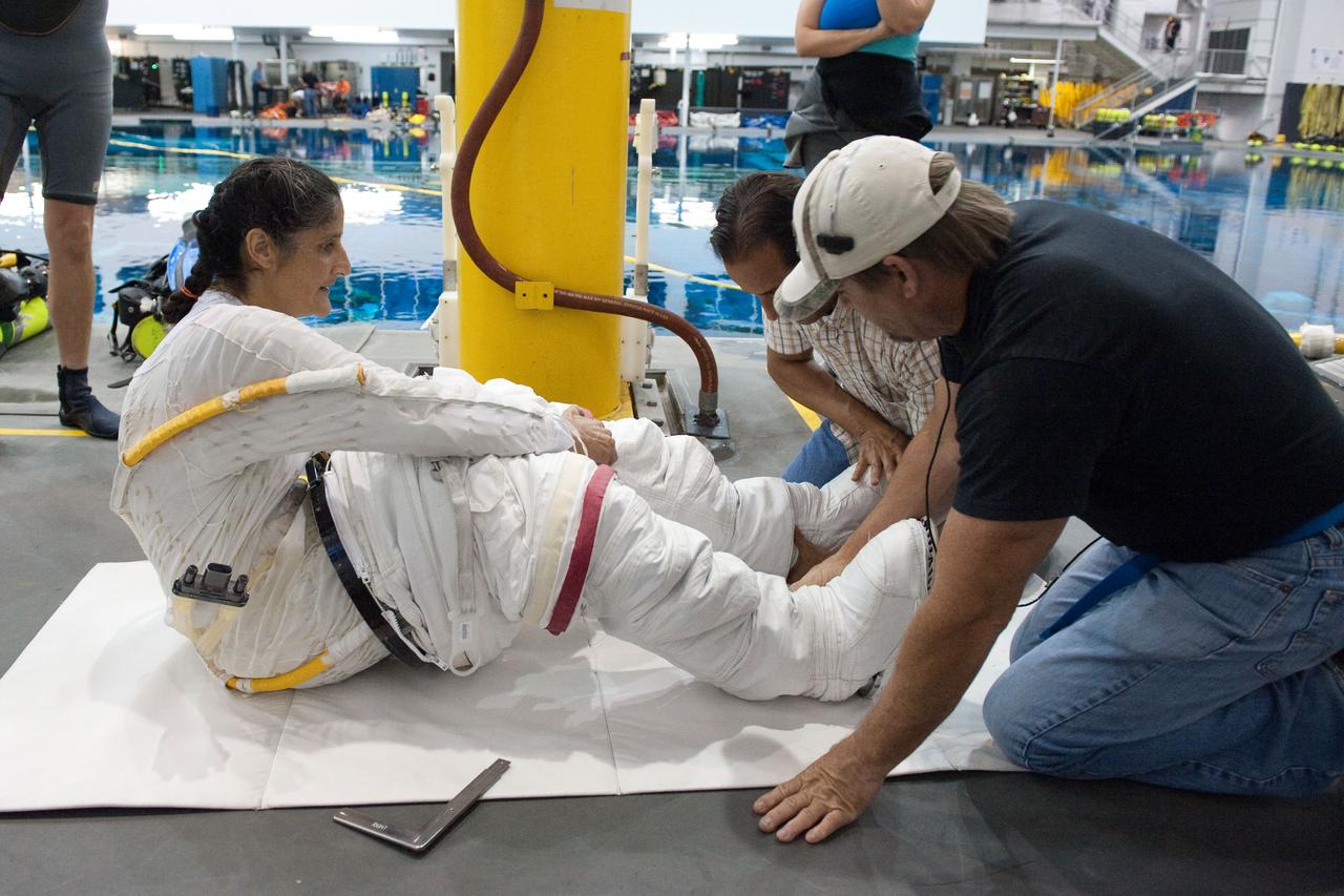 PHOTO DATE: 09-16-11  LOCATION: NBL - Pool Topside    SUBJECT: Expedition 31 crew members Suni Williams and Aki Hoshide conduct pre-test briefings, preparations and then suit up for EVA training before entering the pool at the Sonny Carter Training Facility. PHOTOGRAPHER: Devin Boldt 