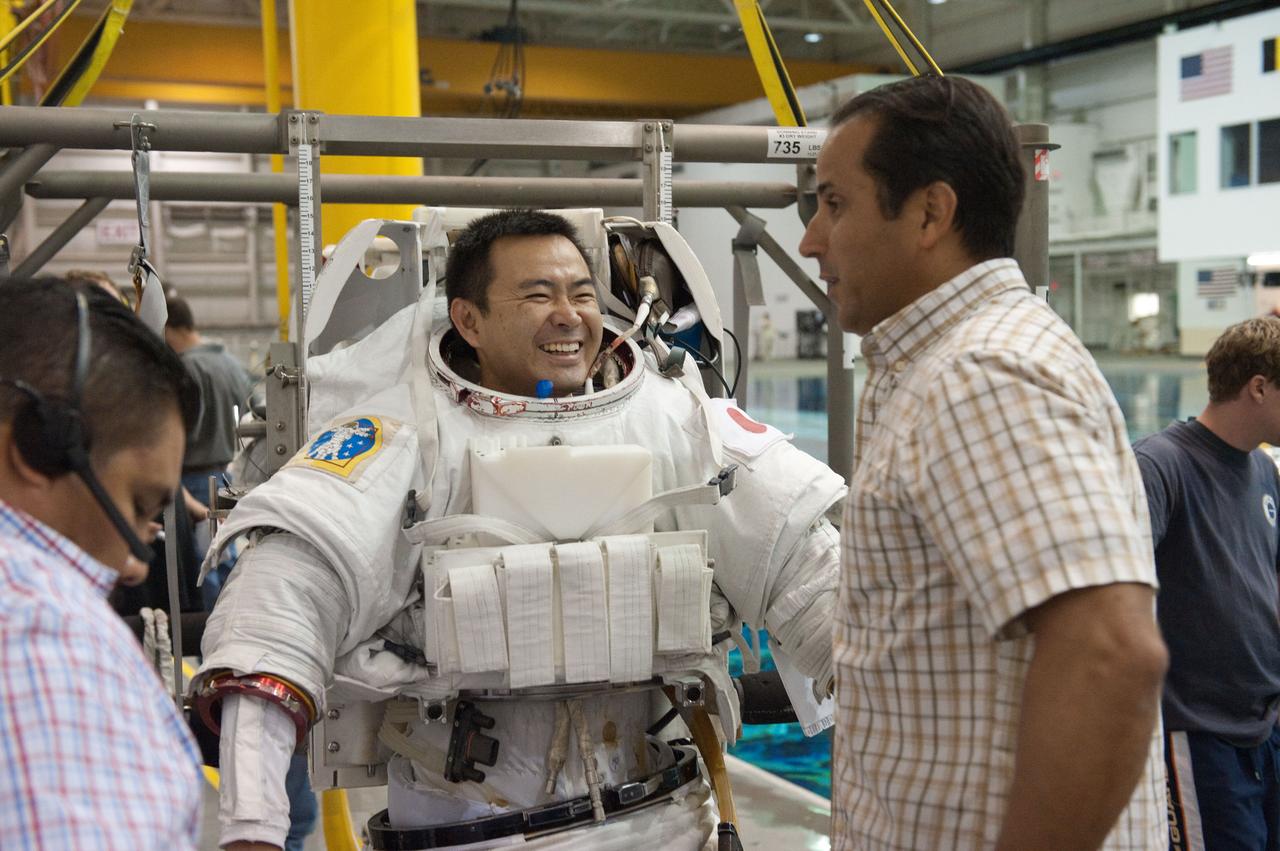 PHOTO DATE: 09-16-11  LOCATION: NBL - Pool Topside    SUBJECT: Expedition 31 crew members Suni Williams and Aki Hoshide conduct pre-test briefings, preparations and then suit up for EVA training before entering the pool at the Sonny Carter Training Facility. PHOTOGRAPHER: Devin Boldt 