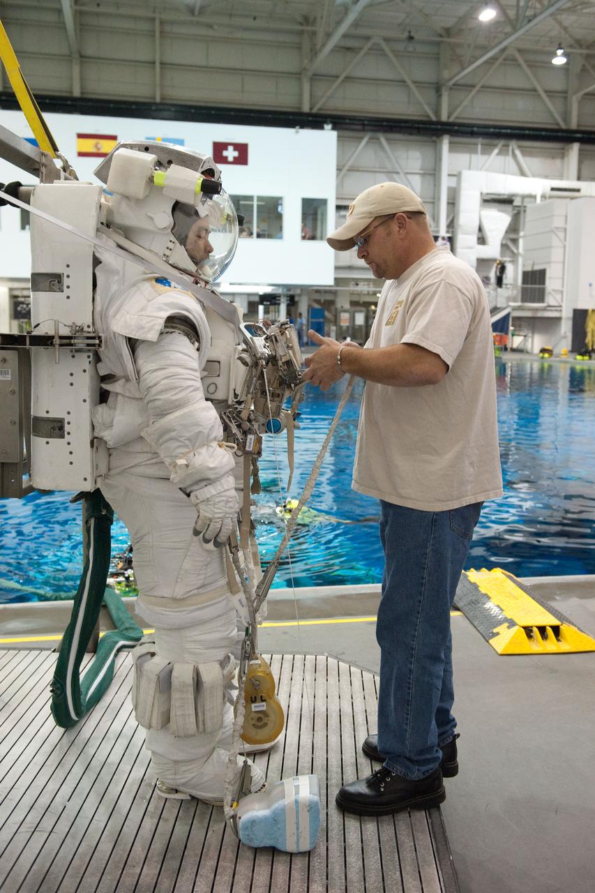 PHOTO DATE: 09-16-11  LOCATION: NBL - Pool Topside    SUBJECT: Expedition 31 crew members Suni Williams and Aki Hoshide conduct pre-test briefings, preparations and then suit up for EVA training before entering the pool at the Sonny Carter Training Facility. PHOTOGRAPHER: Devin Boldt 
