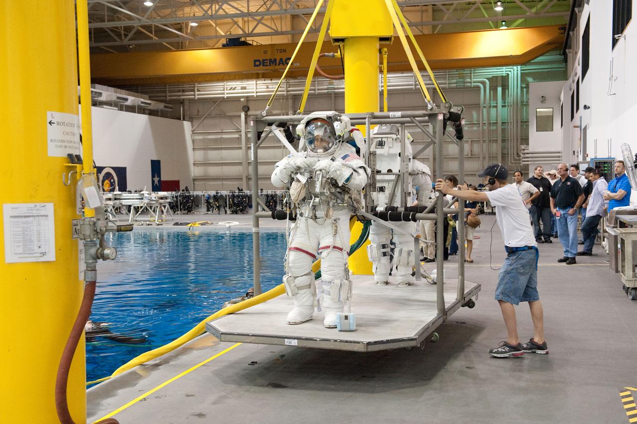 PHOTO DATE: 09-16-11  LOCATION: NBL - Pool Topside    SUBJECT: Expedition 31 crew members Suni Williams and Aki Hoshide conduct pre-test briefings, preparations and then suit up for EVA training before entering the pool at the Sonny Carter Training Facility. PHOTOGRAPHER: Devin Boldt 