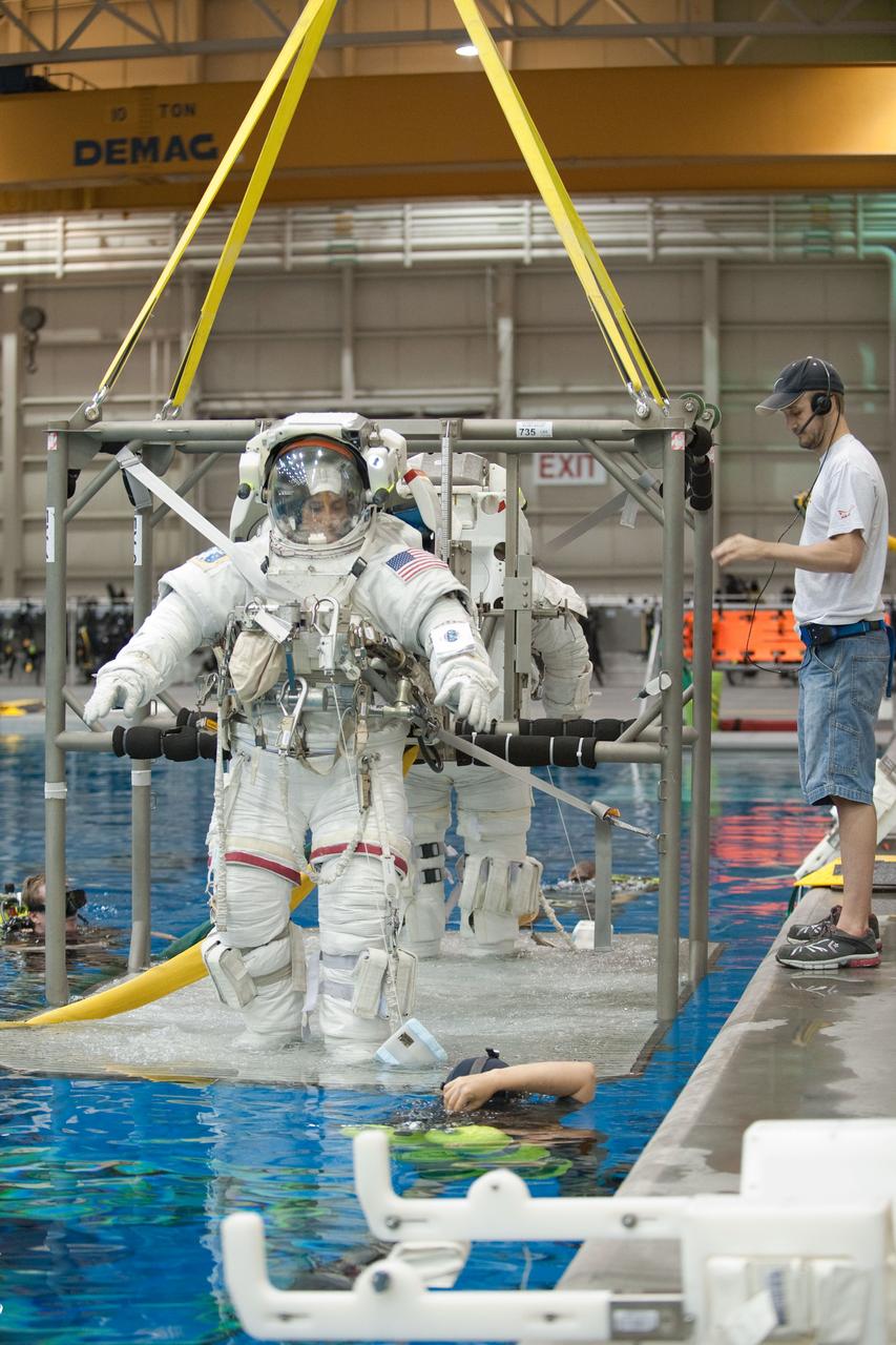 PHOTO DATE: 09-16-11  LOCATION: NBL - Pool Topside    SUBJECT: Expedition 31 crew members Suni Williams and Aki Hoshide conduct pre-test briefings, preparations and then suit up for EVA training before entering the pool at the Sonny Carter Training Facility. PHOTOGRAPHER: Devin Boldt 