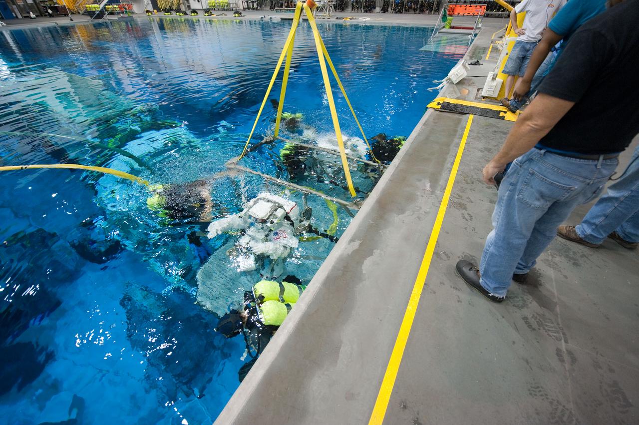 PHOTO DATE: 09-16-11  LOCATION: NBL - Pool Topside    SUBJECT: Expedition 31 crew members Suni Williams and Aki Hoshide conduct pre-test briefings, preparations and then suit up for EVA training before entering the pool at the Sonny Carter Training Facility. PHOTOGRAPHER: Devin Boldt 