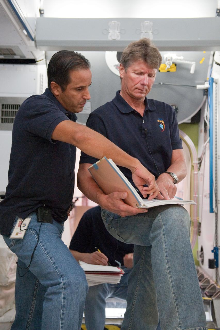 DATE: 10-17-11 LOCATION: Building 9 - ISS Trainers SUBJECT: Expedition 31/32 crew—Padalka, Revin and Acaba—during some of their Emergency Scenarios training. PHOTOGRAPHER: Lauren Harnett