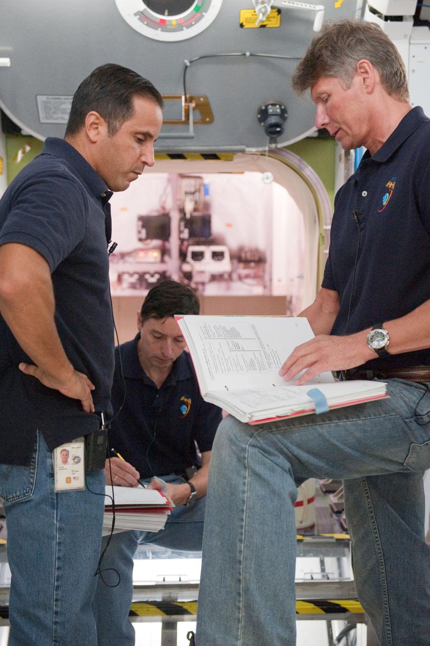 DATE: 10-17-11 LOCATION: Building 9 - ISS Trainers SUBJECT: Expedition 31/32 crew—Padalka, Revin and Acaba—during some of their Emergency Scenarios training. PHOTOGRAPHER: Lauren Harnett