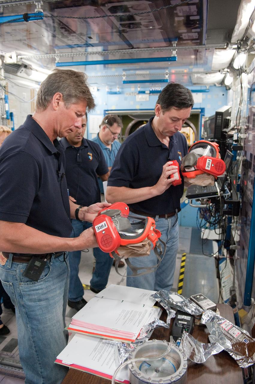 DATE: 10-17-11 LOCATION: Building 9 - ISS Trainers SUBJECT: Expedition 31/32 crew—Padalka, Revin and Acaba—during some of their Emergency Scenarios training. PHOTOGRAPHER: Lauren Harnett