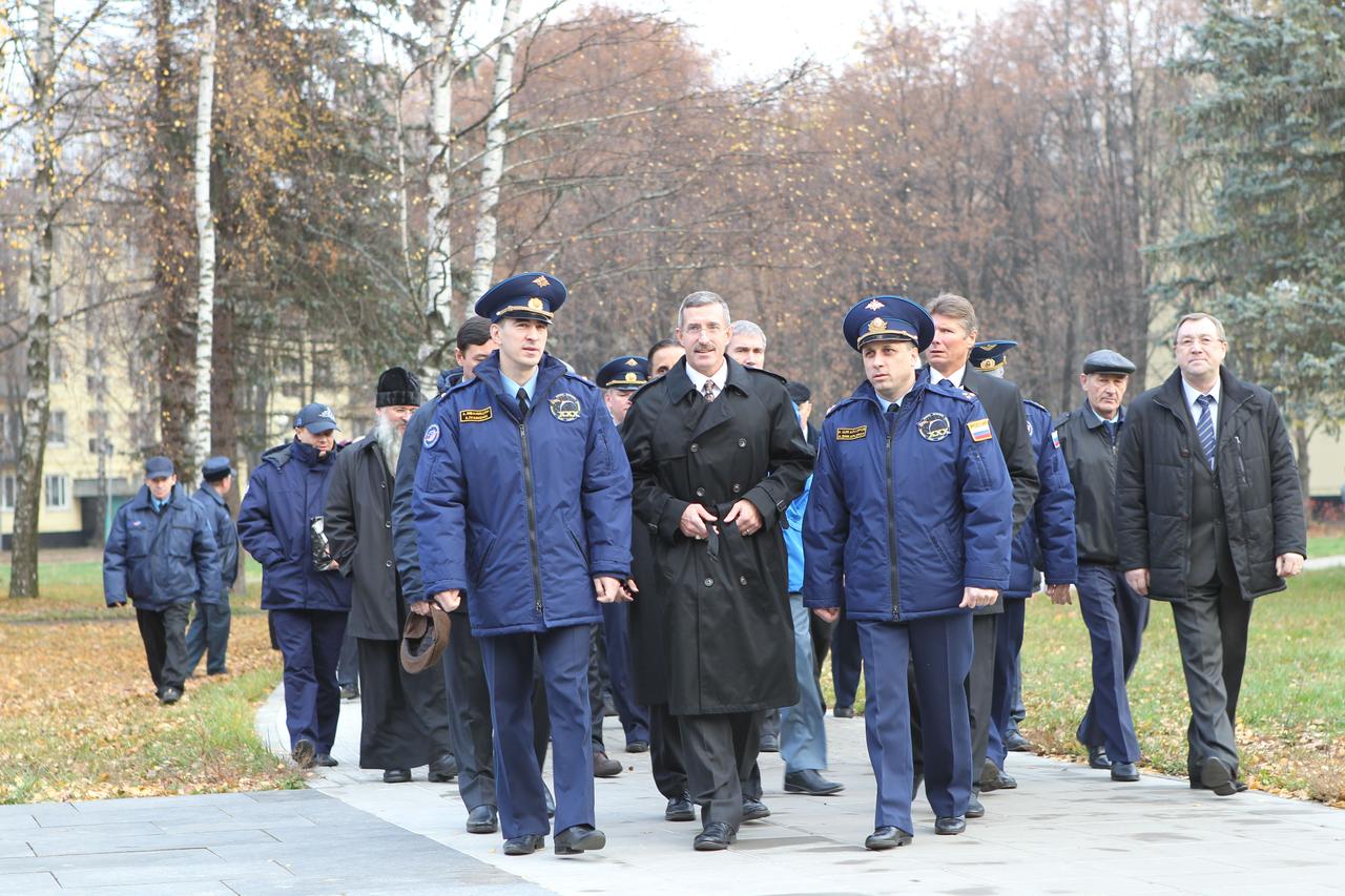 At the Gagarin Cosmonaut Training Center in Star City, Russia, Expedition 29/30 Flight Engineer Anatoly Ivanishin (foreground, left), NASA’s Dan Burbank (center) and Russian Soyuz Commander Anton Shkaplerov (right) lead a delegation as they walk to their bus October 31, 2011, preparing to depart for their launch site in Baikonur, Kazakhstan. The trio will launch November 14 from Baikonur on their Soyuz TMA-22 spacecraft for the International Space Station.  Credit: NASA 
