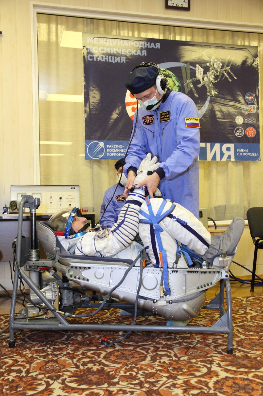  At the Integration Facility at the Baikonur Cosmodrome in Kazakhstan, a technician conducts a leak check of the Russian Sokol launch and entry suit of Expedition 30 Commander Dan Burbank of NASA during the first of two “fit checks” of the Soyuz TMA-22 spacecraft he, Flight Engineer Anatoly Ivanishin and Soyuz Commander Anton Shkaplerov will launch in November 14 from Baikonur to the International Space Station.  November 1, 2011  Credit: NASA/Victor Zelentsov 