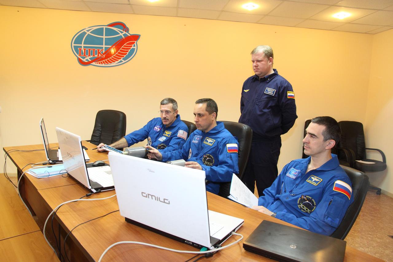 In Baikonur, Kazakhstan, Expedition 30 Commander Dan Burbank of NASA (left), Soyuz Commander Anton Shkaplerov (center) and Flight Engineer Anatoly Ivanishin review docking procedures on a laptop computer during training at their Cosmonaut Hotel crew quarters November 8, 2011. The trio will launch in the Soyuz TMA-22 spacecraft from Baikonur on November 14 bound for the International Space Station. Credit: NASA/Victor Zelentsov