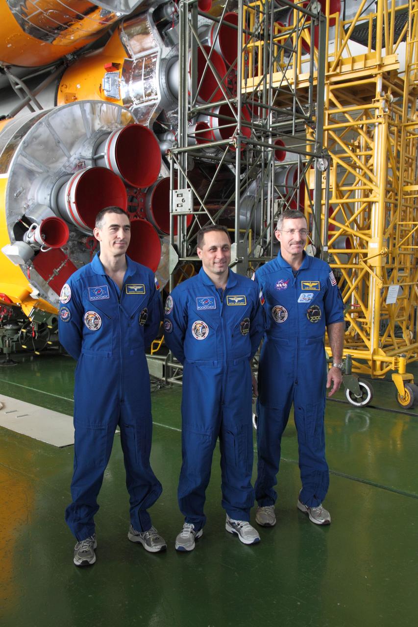 At the Baikonur Cosmodrome in Kazakhstan, Expedition 30 Flight Engineer Anatoly Ivanishin (left), Soyuz Commander Anton Shkaplerov (center) and Expedition 30 Commander Dan Burbank of NASA (right) pose for pictures in front of their Soyuz booster rocket November 9, 2011 as they prepare for launch November 14 on the Soyuz TMA-22 spacecraft from Baikonur to the International Space Station.  Credit: NASA/Victor Zelentsov 
