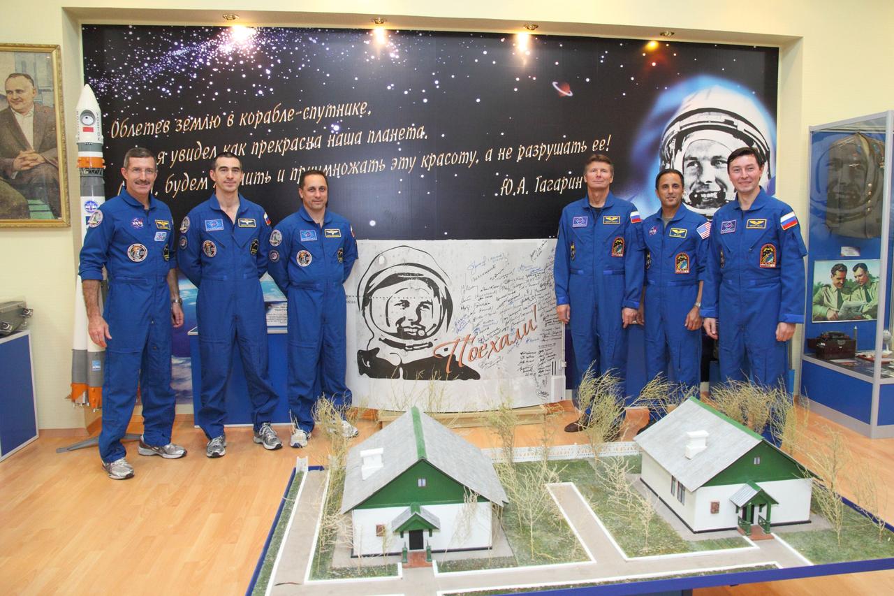 At the Baikonur Cosmodrome in Kazakhstan, the Expedition 30 prime and backup crews pose for pictures around a poster of Yuri Gagarin, the first human to fly in space, as they toured the Korolev Museum November 9, 2011 following a final inspection of their Soyuz TMA-22 spacecraft. From left to right are the prime crew, Expedition 30 Commander Dan Burbank of NASA, Flight Engineer Anatoly Ivanishin, Soyuz Commander Anton Shkaplerov, and the backup crew, Gennady Padalka, Joe Acaba of NASA and Sergei Revin.  Burbank, Shkaplerov and Ivanishin are completing training for launch November 14 on the Soyuz TMA-22 from Baikonur to the International Space Station.  Credit: NASA/Victor Zelentsov 