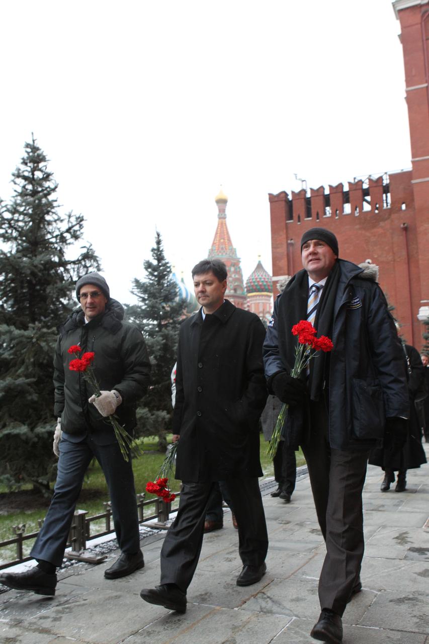 At the Kremlin Wall in Moscow, the next trio to launch to the International Space Station prepare to lay flowers at the site where Russian space heroes are interred during their traditional ceremony Dec. 1, 2011. From left to right are Expedition 30 NASA Flight Engineer Don Pettit, Soyuz Commander Oleg Kononenko and Flight Engineer Andre Kuipers of the European Space Agency. The crewmembers will launch from the Baikonur Cosmodrome in Kazakhstan on Dec. 21 on their Soyuz TMA-03M spacecraft.  Credit: NASA 