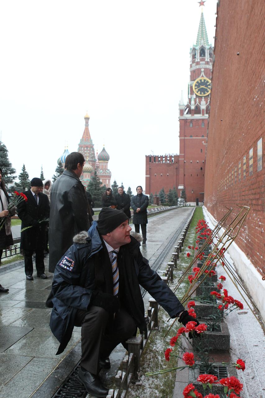  At the Kremlin Wall in Moscow, Expedition 30 Flight Engineer Andre Kuipers of the European Space Agency prepares to lay flowers at the site where Russian space heroes are interred during a traditional ceremony Dec. 1, 2011. Kuipers, Soyuz Commander Oleg Kononenko and NASA Flight Engineer Don Pettit will launch on Dec. 21 from the Baikonur Cosmodrome in Kazakhstan on their Soyuz TMA-03M spacecraft to the International Space Station.  Credit: NASA 