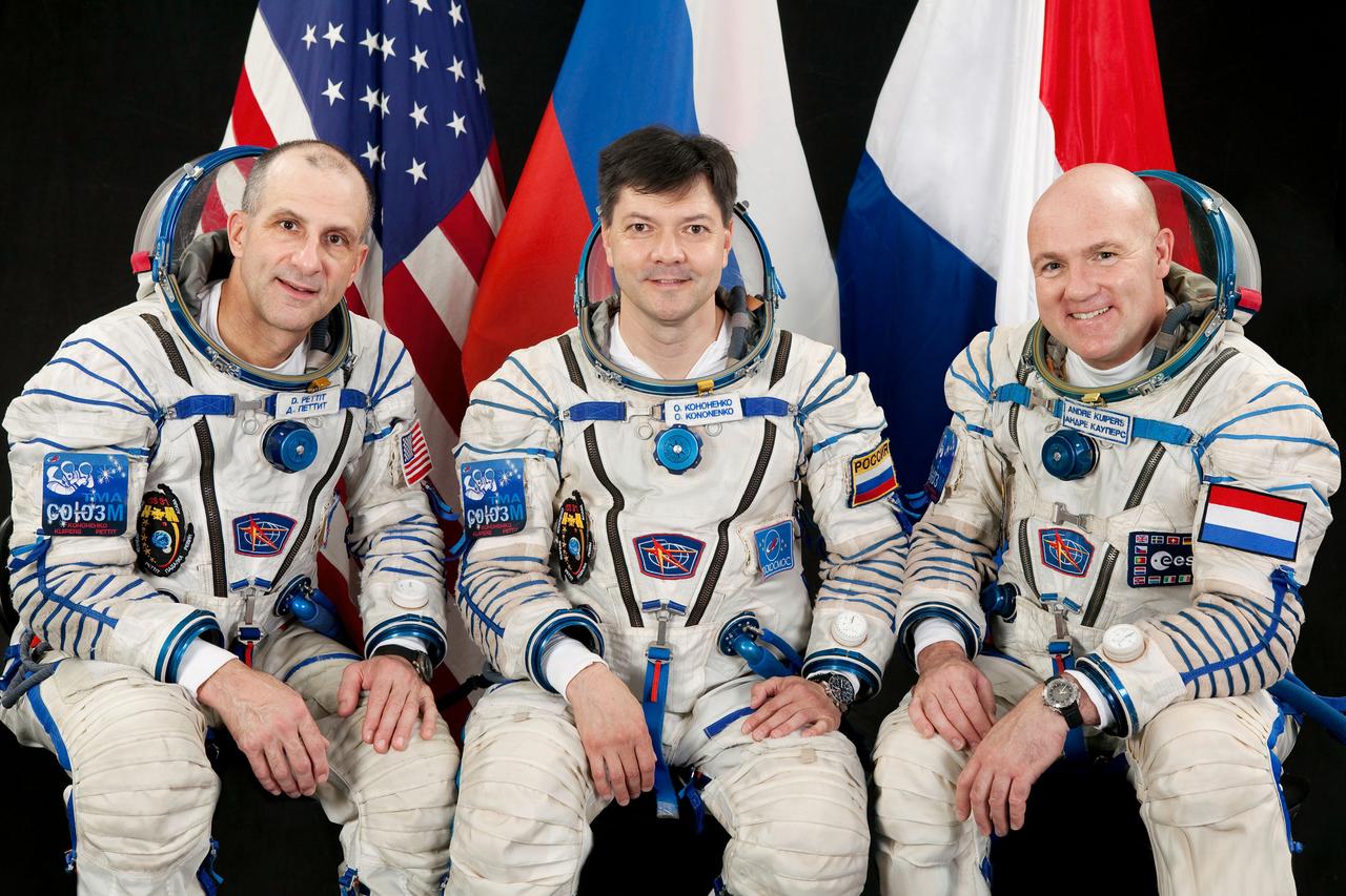 JSC2011-E-215048 (15 Aug. 2011) --- Attired in Russian Sokol launch and entry suits, Russian cosmonaut Oleg Kononenko (center), Expedition 30 flight engineer and Expedition 31 commander; along with NASA astronaut Don Pettit (left) and European Space Agency astronaut Andre Kuipers, both Expedition 30/31 flight engineers, take a break from training in Star City, Russia to pose for a portrait. Photo credit: Gagarin Cosmonaut Training Center
