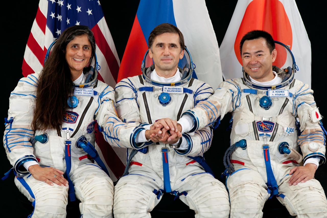 JSC2011-E-215050 (15 Aug. 2011) --- Attired in Russian Sokol launch and entry suits, NASA astronaut Suni Williams, Russian cosmonaut Yuri Malenchenko (center) and Japan Aerospace Exploration Agency astronaut Aki Hoshide, all Expedition 30 backup crew members, take a break from training in Star City, Russia to pose for a portrait. Photo credit: Gagarin Cosmonaut Training Center