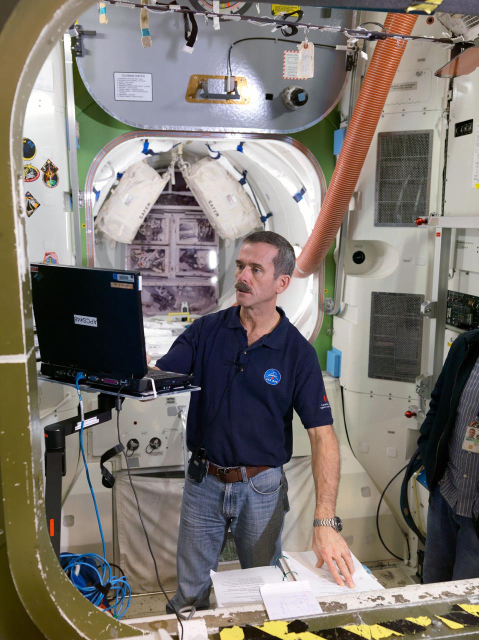JSC2011-E-215226 (5 Dec. 2011) --- Canadian Space Agency astronaut Chris Hadfield, Expedition 34 flight engineer and Expedition 35 commander, participates in an emergency scenario training session in an International Space Station mock-up/trainer in the Space Vehicle Mock-up Facility at NASA's Johnson Space Center. Photo credit: NASA