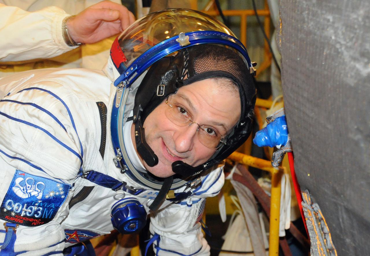 At the Baikonur Cosmodrome in Kazakhstan, Expedition 30 Flight Engineer Don Pettit flashes a smile as he climbs aboard his Soyuz TMA-03M spacecraft Dec. 9, 2011 during a dress rehearsal fit check. Pettit will launch Dec. 21 to the International Space Station with Soyuz Commander Oleg Kononenko and Flight Engineer Andre Kuipers of the European Space Agency.  Credit: NASA 