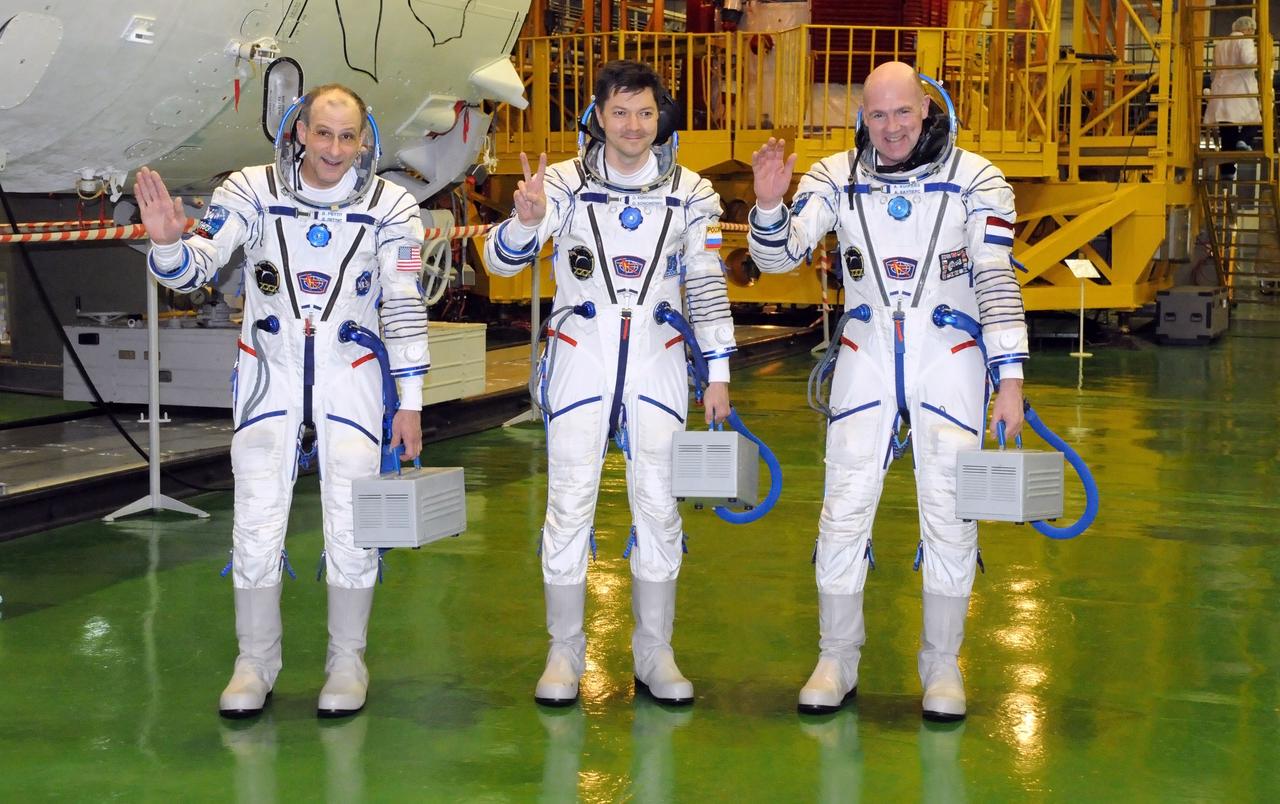 At the Baikonur Cosmodrome in Kazakhstan, the three crewmembers who will round out the Expedition 30 crew on the International Space Station pose for pictures following a fit check in their Soyuz TMA-03M spacecraft Dec. 9, 2011. NASA Flight Engineer Don Pettit (left), Soyuz Commander Oleg Kononenko (center) and Flight Engineer Andre Kuipers (right) will launch Dec. 21 to the station from Baikonur.  Credit: NASA 
