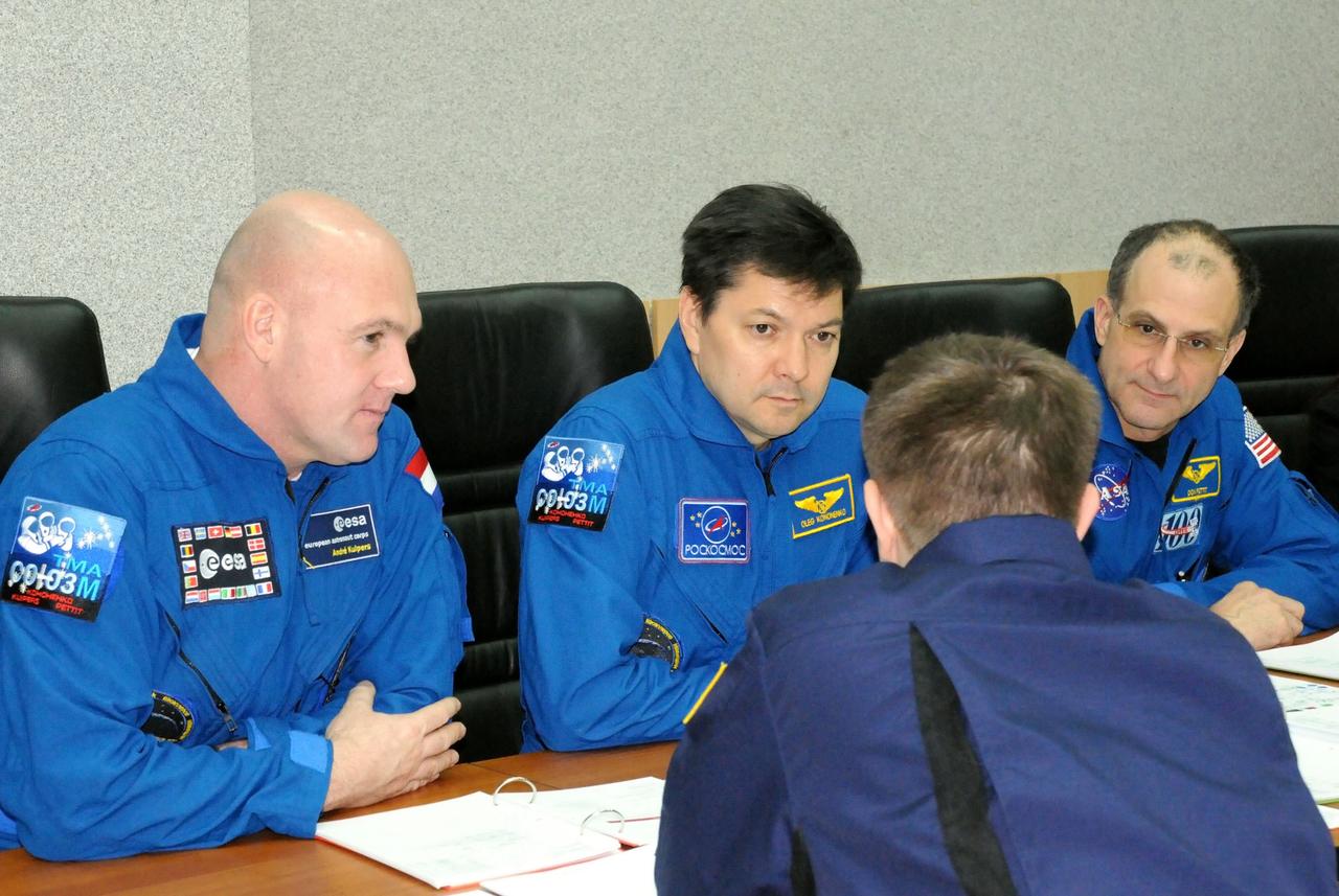 At their crew quarters at the Cosmonaut Hotel in Baikonur, Kazakhstan, Expedition 30 Flight Engineer Andre Kuipers of the European Space Agency (left), Soyuz Commander Oleg Kononenko (center) and NASA Flight Engineer Don Pettit (right) listen to a review of flight data file information from a training instructor Dec. 15, 2011 as the trio prepares for launch Dec. 21 to the International Space Station in their Soyuz TMA-03M spacecraft from Baikonur.  Credit: NASA 