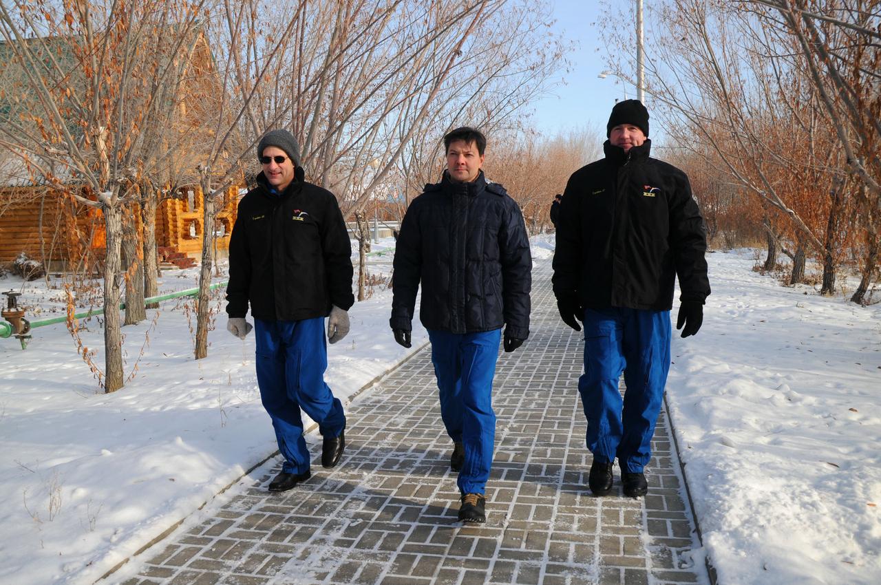 Braced against the cold of single digit temperatures, Expedition 30 NASA Flight Engineer Don Pettit (left), Soyuz Commander Oleg Kononenko (center) and Flight Engineer Andre Kuipers of the European Space Agency (right) take a walk on the grounds of their Cosmonaut Hotel crew quarters in Baikonur, Kazakhstan Dec. 15, 2011 as they prepare for launch on Dec. 21 in their Soyuz TMA-03M spacecraft from Baikonur to the International Space Station.  Credit: NASA 