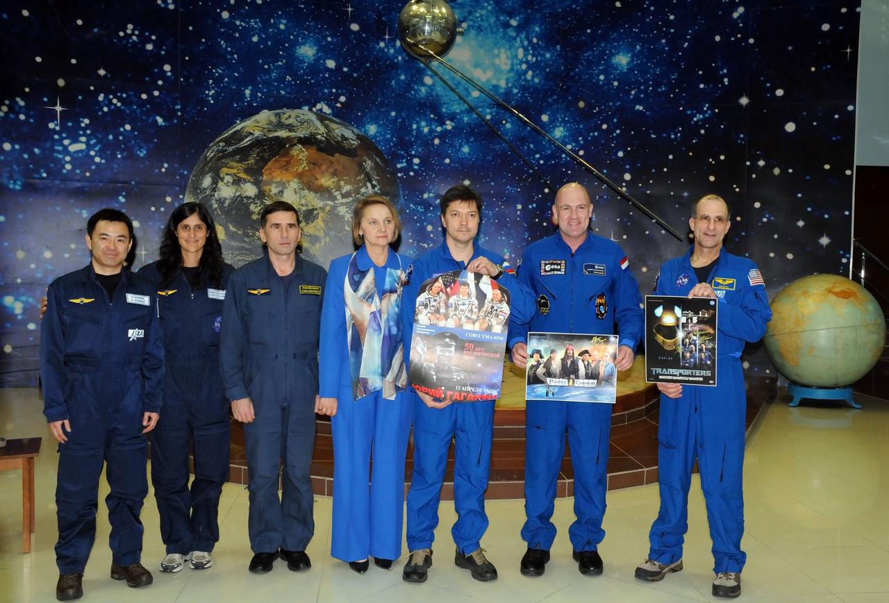 At the Korolev Museum in the Baikonur Cosmodrome in Kazakhstan, the prime and backup crews preparing for launch to the International Space Station to round out the Expedition 30 crew pose for pictures December 16, 2011 as they wrap up training for launch on Dec. 21 on the Soyuz TMA-03M spacecraft. From left to right are backup Flight Engineer Aki Hoshide of the Japan Aerospace Exploration Agency, backup Flight Engineer Suni Williams of NASA, backup Soyuz Commander Yuri Malenchenko, the host greeting the crew in the museum, prime Soyuz Commander Oleg Kononenko, prime Flight Engineer Andre Kuipers of the European Space Agency and prime Flight Engineer Don Pettit of NASA. Kononenko, Kuipers and Pettit will spend five and a half months on the complex.  Credit: NASA 