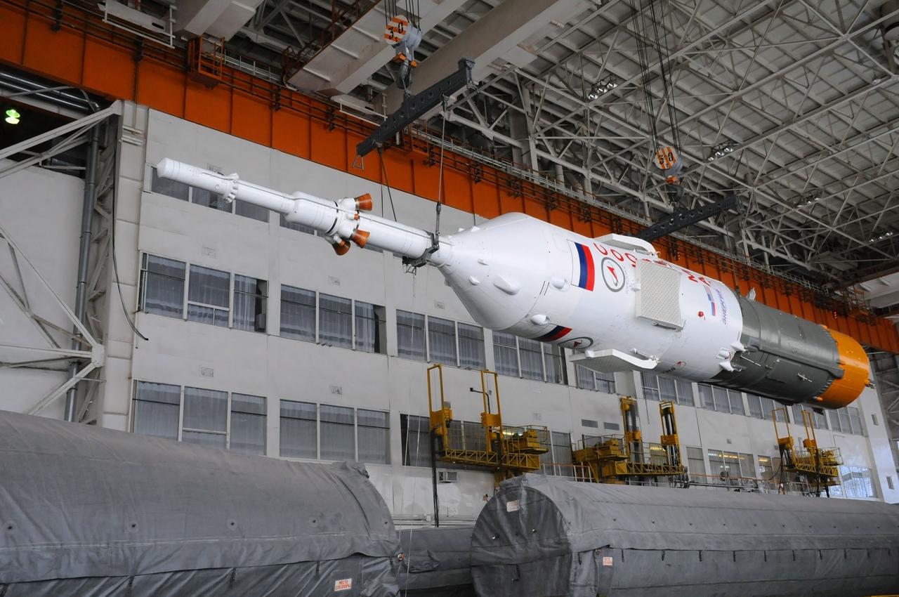 At the Integration Facility at the Baikonur Cosmodrome in Kazakhstan, the upper stage of the Soyuz booster rocket containing the Soyuz TMA-03M spacecraft is positioned for mating with the rest of the rocket Dec. 18, 2011. Preparations continue for launch from Baikonur to the International Space Station on Dec. 21 with Expedition 30 Flight Engineer Don Pettit of NASA, Soyuz Commander Oleg Kononenko and Flight Engineer Andre Kuipers of the European Space Agency. Photo credit: NASA