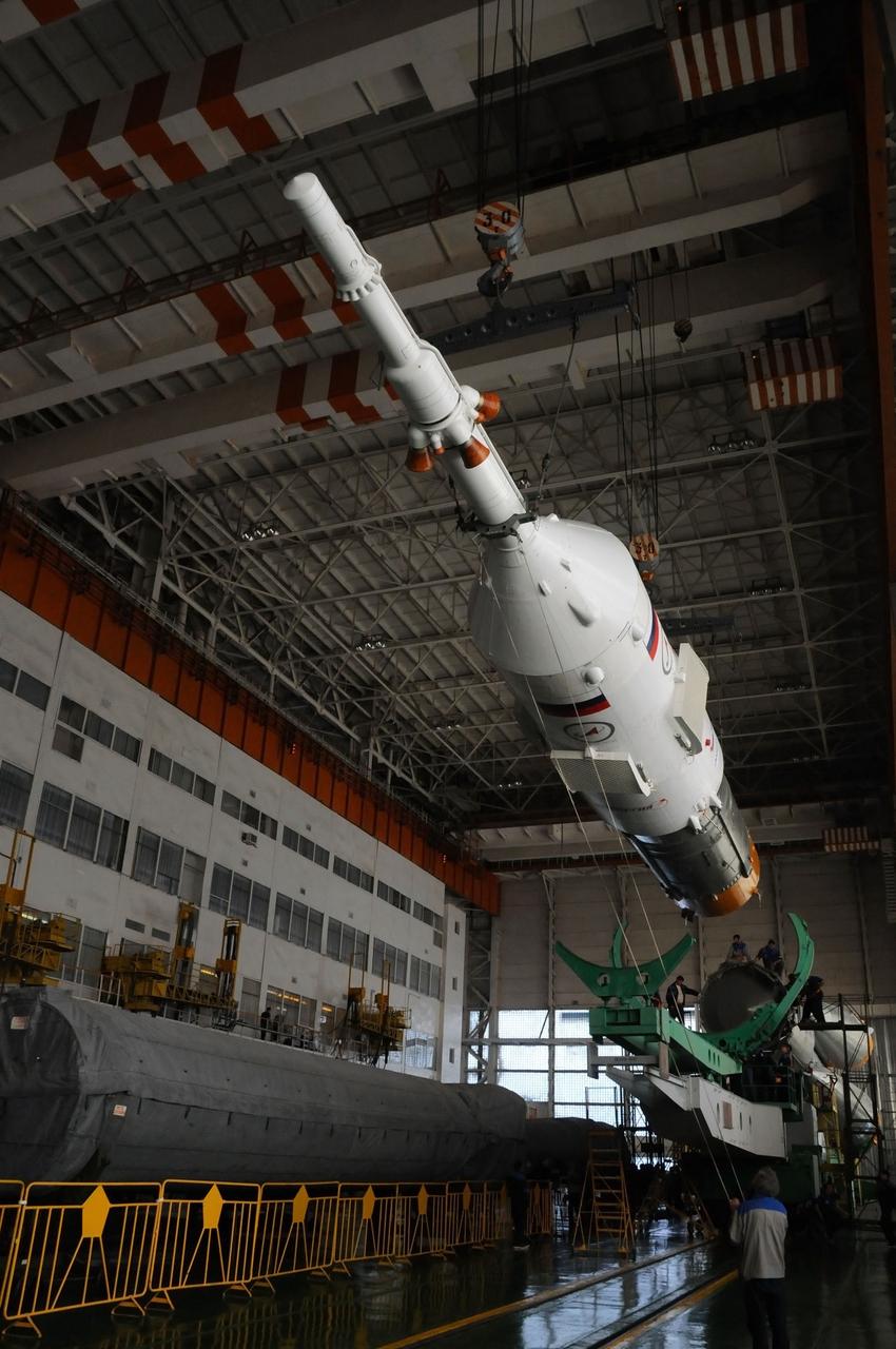 At the Integration Facility at the Baikonur Cosmodrome in Kazakhstan, the upper stage of the Soyuz booster rocket containing the Soyuz TMA-03M spacecraft is positioned for mating with the rest of the rocket Dec. 18, 2011. Preparations continue for launch from Baikonur to the International Space Station on Dec. 21 with Expedition 30 Flight Engineer Don Pettit of NASA, Soyuz Commander Oleg Kononenko and Flight Engineer Andre Kuipers of the European Space Agency. Photo credit: NASA
