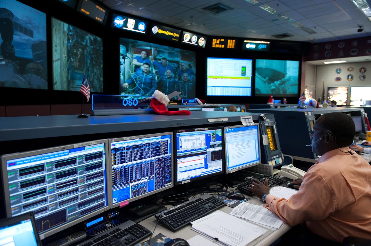 PHOTO DATE: 12-23-11 LOCATION: Bldg. 30M, FCR-1 SUBJECT: Expedition 30 flight controllers on console in FCR-1 during the docking of Don Pettit, Oleg Kononenko and Andre Kuipers to the ISS. PHOTOGRAPHER: Lauren Harnett