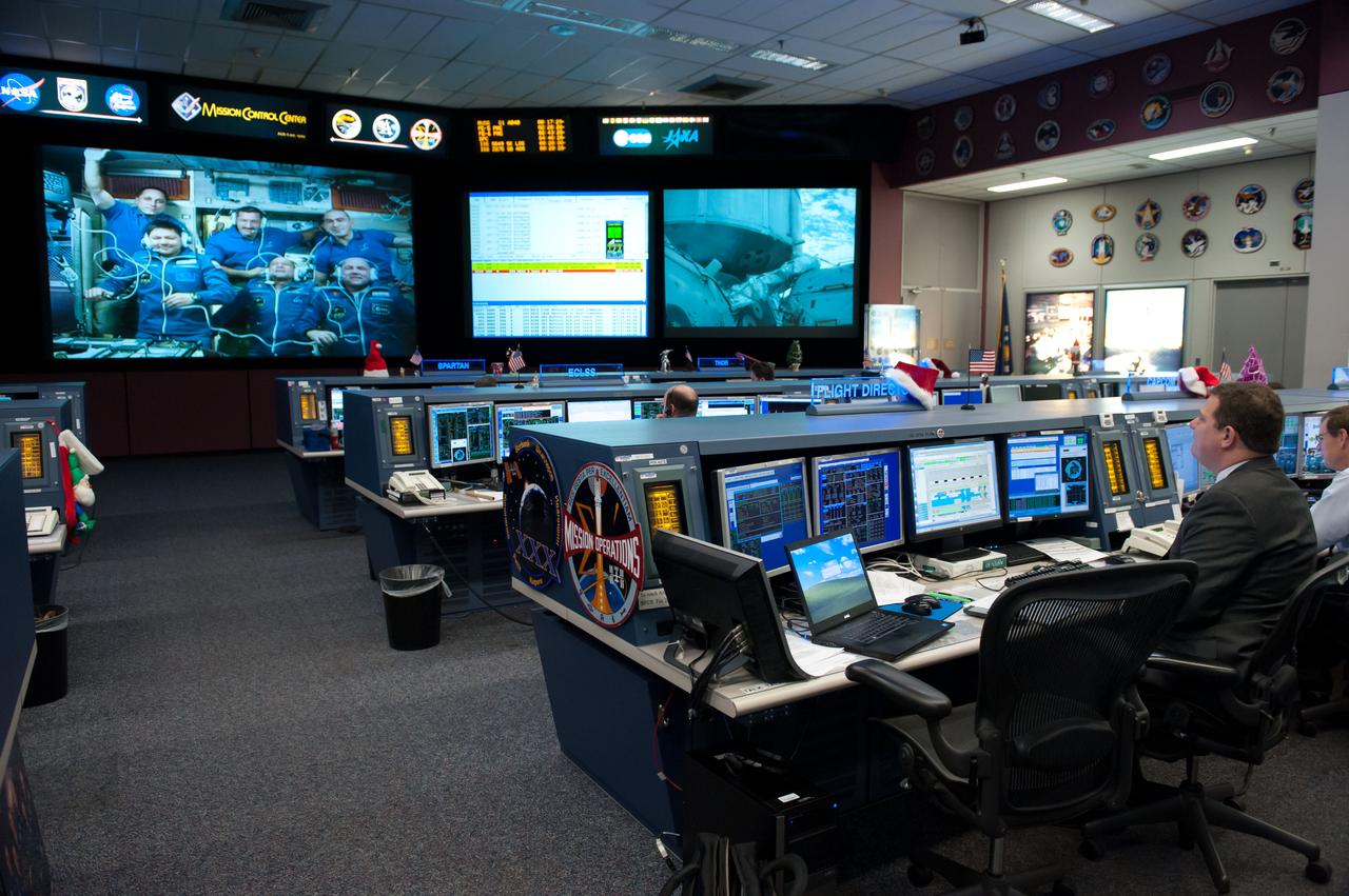 PHOTO DATE: 12-23-11 LOCATION: Bldg. 30M, FCR-1 SUBJECT: Expedition 30 flight controllers on console in FCR-1 during the docking of Don Pettit, Oleg Kononenko and Andre Kuipers to the ISS. PHOTOGRAPHER: Lauren Harnett