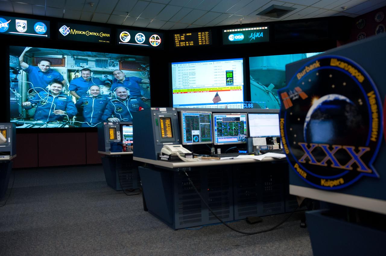 PHOTO DATE: 12-23-11 LOCATION: Bldg. 30M, FCR-1 SUBJECT: Expedition 30 flight controllers on console in FCR-1 during the docking of Don Pettit, Oleg Kononenko and Andre Kuipers to the ISS. PHOTOGRAPHER: Lauren Harnett