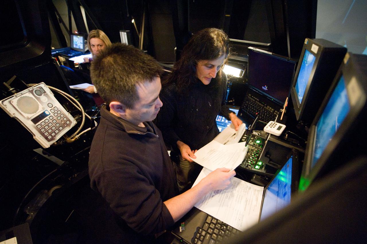 Expedition 33 crew members Suni Williams and Aki Hoshide at the SSRMS Track and Capture training station in the SES Dome.  Photo Date: January 13, 2012.  Location: Building 16, SES Dome.  Photographer: Robert Markowitz