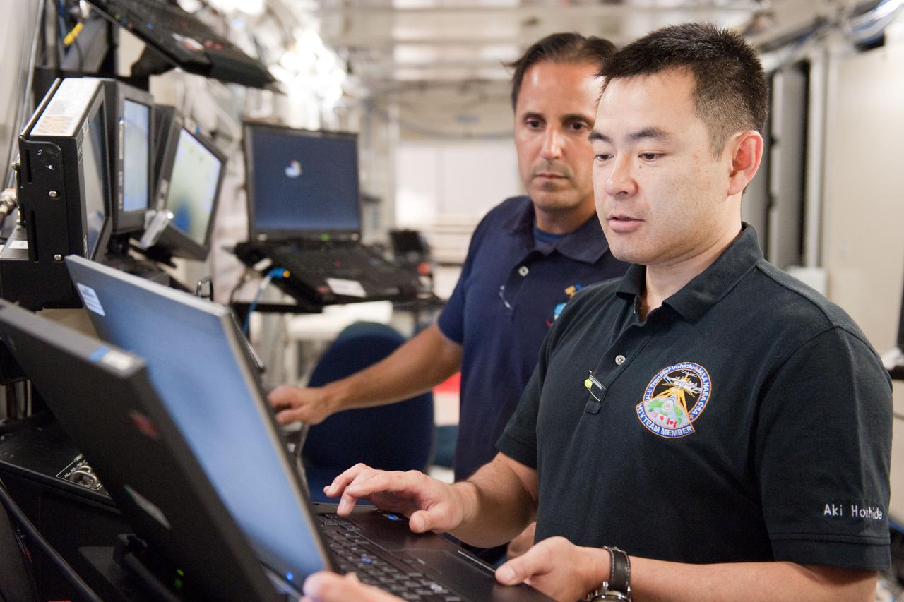 Date: 03-08-12 Location: Bldg 5, SSTF Subject: Expedition 32 (Soyuz 31) crew membesr Aki Hoshide, Sunita Williams and Joseph Acaba  during JAXA's HTV sim, FE Rendezvous/Deployment in building 5's space station training facility with Robo instructor Melanie Miller.  Photographer: James Blair