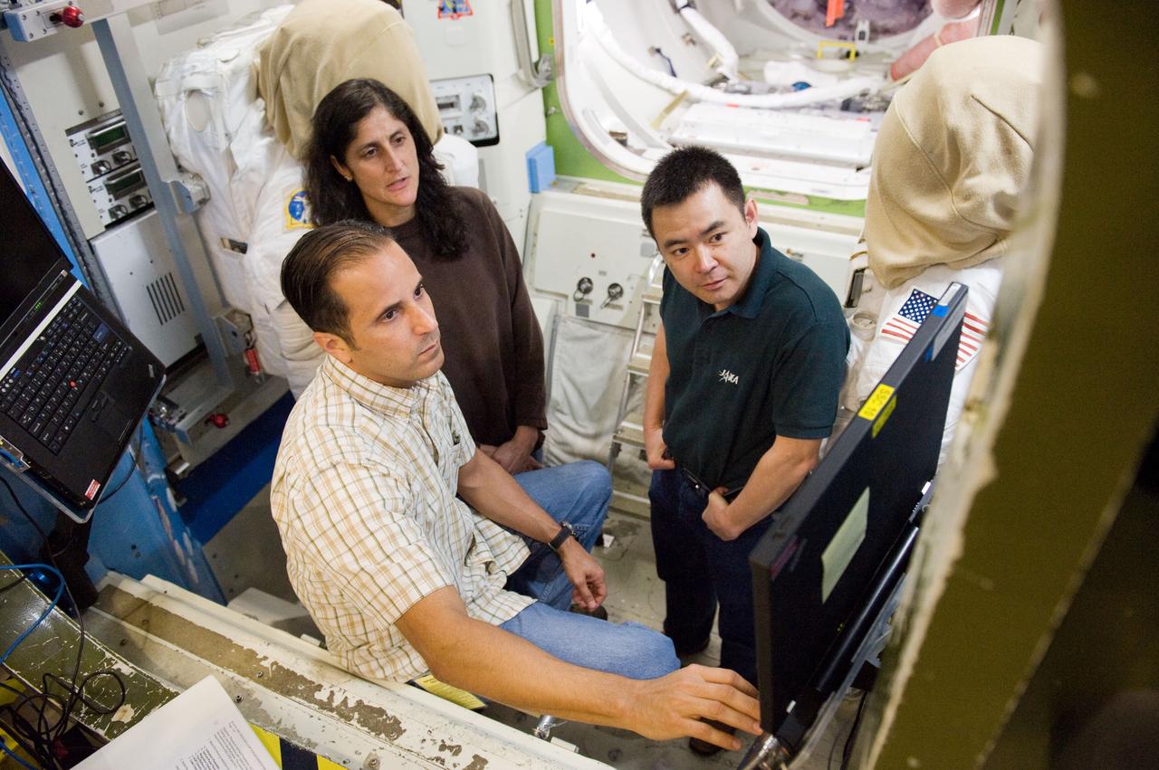 Date: 03-13-12 Location: Bldg 9NW, ISS Airlock Subject: Expedition 32 (Soyuz 31) crew members Aki Hoshide, Sunita Williams and Joe Acaba during ISS EVA planning and preparation Photographer: James Blair